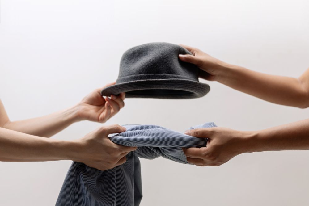 People swapping clothes, symbolizing changing a Shopify theme and its affects on SEO